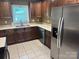 Modern kitchen with stainless steel appliances, granite countertops, and tile flooring at 907 Mcgowan Rd, Shelby, NC 28150