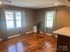 Spacious living room with multiple windows allowing for plenty of natural light and hardwood floors at 907 Mcgowan Rd, Shelby, NC 28150