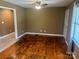 Cozy living room featuring beautiful hardwood floors, a ceiling fan, and ample natural light at 907 Mcgowan Rd, Shelby, NC 28150