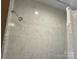 This shower features sleek subway tile and chrome fixtures for a clean and modern look at 907 Mcgowan Rd, Shelby, NC 28150