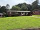 Well-maintained single-story brick house with a covered front porch and a green, spacious yard at 908 Mcgowan Rd, Shelby, NC 28150