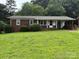 Charming single-story brick home featuring a welcoming front porch and lush green lawn at 908 Mcgowan Rd, Shelby, NC 28150