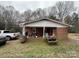 Cozy backyard with brick patio, picnic table, and mature trees, perfect for outdoor relaxation at 910 Mcgowan Rd, Shelby, NC 28150