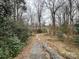 A long driveway leads to a private, wooded lot, creating a serene and secluded setting at 910 Mcgowan Rd, Shelby, NC 28150