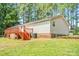 Wide backyard with a wooden deck and stairs and lush greenery at 10230 Hagers Rd, Huntersville, NC 28078