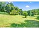 Lush green backyard with mature trees and abundant space at 10230 Hagers Rd, Huntersville, NC 28078