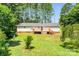 Expansive backyard featuring a wooden deck and mature trees at 10230 Hagers Rd, Huntersville, NC 28078