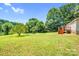 Spacious backyard with green lawn, trees, and deck at 10230 Hagers Rd, Huntersville, NC 28078