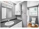 Small bathroom featuring a single vanity, black countertop, and tiled shower at 10230 Hagers Rd, Huntersville, NC 28078