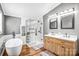 Bright bathroom featuring double vanity, a soaking tub and sleek glass shower at 10230 Hagers Rd, Huntersville, NC 28078