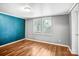 Comfortable bedroom with wood-look floors and bright natural light at 10230 Hagers Rd, Huntersville, NC 28078