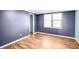 Cozy bedroom featuring wood-look floors and lots of natural light at 10230 Hagers Rd, Huntersville, NC 28078