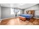 Comfortable bedroom with hardwood floors, ample natural light, and neutral tones, creating a calm and inviting space at 10230 Hagers Rd, Huntersville, NC 28078