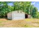 Exterior view of a white detached garage with shed at 10230 Hagers Rd, Huntersville, NC 28078