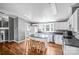 Charming kitchen boasting white cabinetry, stainless steel appliances, an island with seating, and ample natural light at 10230 Hagers Rd, Huntersville, NC 28078
