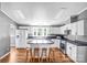 Bright kitchen featuring white cabinetry, modern appliances, hardwood flooring, and a center island for added prep space at 10230 Hagers Rd, Huntersville, NC 28078