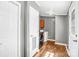 Well-lit laundry room featuring wood-look flooring and modern washer and dryer at 10230 Hagers Rd, Huntersville, NC 28078