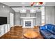 Cozy living room showcasing a modern fireplace, hardwood flooring, blue sofas, and a rustic wood coffee table at 10230 Hagers Rd, Huntersville, NC 28078