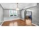 Bright living room with hardwood floors, modern chandelier, arched doorway and large windows providing natural light at 10230 Hagers Rd, Huntersville, NC 28078