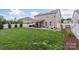 Large backyard with a covered patio, outdoor seating, and a well-maintained lawn at 108 Wrangler Dr, Mooresville, NC 28115