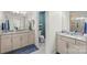 Bright bathroom featuring double sinks, granite countertops, and a separate toilet area at 108 Wrangler Dr, Mooresville, NC 28115