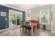 Bright dining room with sliding glass doors, dark accent wall, and modern light fixture at 108 Wrangler Dr, Mooresville, NC 28115