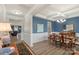 Formal dining room with blue accent wall, coffered ceiling, and an elegant wood dining table set at 108 Wrangler Dr, Mooresville, NC 28115