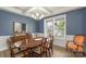 Formal dining room featuring wood floors, a large window, a chandelier and blue walls with white trim at 108 Wrangler Dr, Mooresville, NC 28115