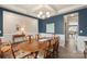 Formal dining room with blue accent wall, coffered ceiling, and an elegant wood dining table set at 108 Wrangler Dr, Mooresville, NC 28115