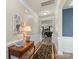 Hallway with a decorative table lamp, leading to the living area with a fireplace and a wall-mounted television at 108 Wrangler Dr, Mooresville, NC 28115