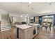 Open-concept kitchen featuring a large island, modern appliances, and seamless flow to the dining and living areas at 108 Wrangler Dr, Mooresville, NC 28115