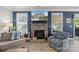 Cozy living room with a stone fireplace, large windows, and comfortable seating at 108 Wrangler Dr, Mooresville, NC 28115