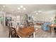 Open-concept living room with hardwood floors, connecting to the kitchen, staircase, and dining room at 108 Wrangler Dr, Mooresville, NC 28115