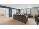 A cozy living room with a sectional sofa, light-colored carpet, and blue walls, provides a relaxing space at 108 Wrangler Dr, Mooresville, NC 28115