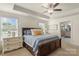 A serene bedroom features a spacious bed, decorative accents, and a doorway to the en-suite bathroom at 108 Wrangler Dr, Mooresville, NC 28115