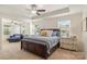 An elegant bedroom with a wooden bed, sitting area, and bright windows, provides a relaxing retreat at 108 Wrangler Dr, Mooresville, NC 28115
