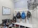 A mudroom with blue and white wallpaper, hooks with backpacks, and shoe storage, offers an organized space at 108 Wrangler Dr, Mooresville, NC 28115