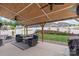 Cozy covered patio with ceiling fans, outdoor seating, and a view of the landscaped backyard at 108 Wrangler Dr, Mooresville, NC 28115