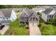 Beautiful aerial view of a two-story home with lush landscaping and a two-car garage in a suburban neighborhood at 11014 Aspen Ridge Nw Ln, Concord, NC 28027