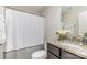 Bathroom featuring granite countertop, vanity, toilet, and shower with neutral-colored curtain at 11014 Aspen Ridge Nw Ln, Concord, NC 28027