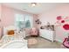 Bedroom with pink walls, white furniture, and a large window for natural light at 11014 Aspen Ridge Nw Ln, Concord, NC 28027