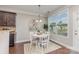 Cozy breakfast nook with a round table, white chairs, and natural light from a large window at 11014 Aspen Ridge Nw Ln, Concord, NC 28027