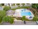 Aerial view of community pool and clubhouse, surrounded by lush landscaping and parking at 11014 Aspen Ridge Nw Ln, Concord, NC 28027