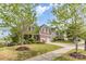 Attractive two-story house with stone accents, an attached two-car garage, and lovely front yard landscaping at 11014 Aspen Ridge Nw Ln, Concord, NC 28027
