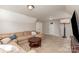 Spacious living room with a sectional couch, TV, and neutral decor at 11014 Aspen Ridge Nw Ln, Concord, NC 28027