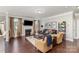 Inviting living room with a fireplace, hardwood floors, stylish decor, and large windows for plenty of light at 11014 Aspen Ridge Nw Ln, Concord, NC 28027