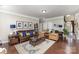 Cozy living room offers hardwood floors, neutral color scheme, comfortable seating, and a decorative area rug at 11014 Aspen Ridge Nw Ln, Concord, NC 28027