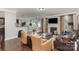 Comfortable living room features hardwood floors, a fireplace, neutral paint and furniture, and ample natural light at 11014 Aspen Ridge Nw Ln, Concord, NC 28027