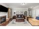 Warm and inviting living room featuring hardwood floors, a fireplace, comfortable seating, and tasteful decorations at 11014 Aspen Ridge Nw Ln, Concord, NC 28027