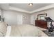 Bright main bedroom featuring neutral walls, large windows, and a tray ceiling at 11014 Aspen Ridge Nw Ln, Concord, NC 28027